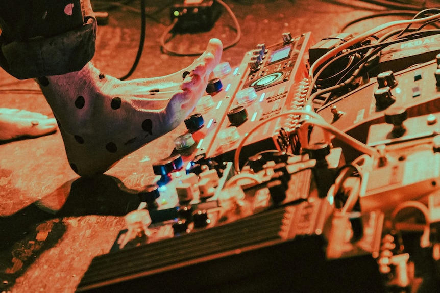 A bare foot near looping and effects pedals.