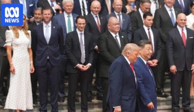 Who is in President Trump's entourage of billionaires and executives in Beijing?