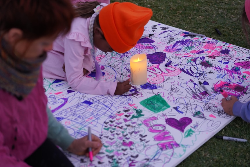 A young girl drawing.