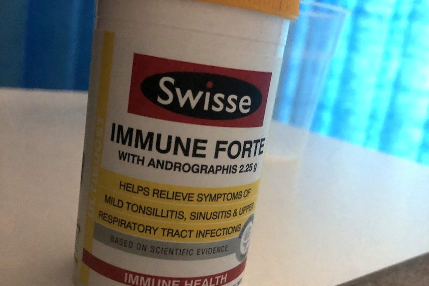 Bottle of medicine sitting on table