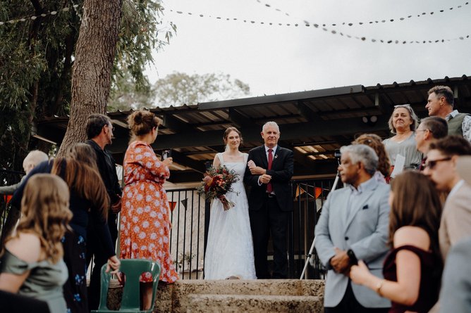 Gabriella walking down the aisle with her father.