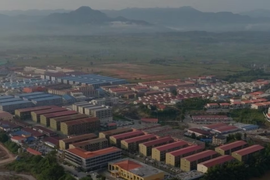 Apartment buildings against mountains taken from an aerial perspective.