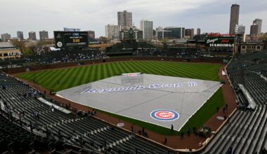 A rain tarp covers the infield at Wrigley Field during a rain delay before a baseball game. (AP Photo/Paul Beaty)