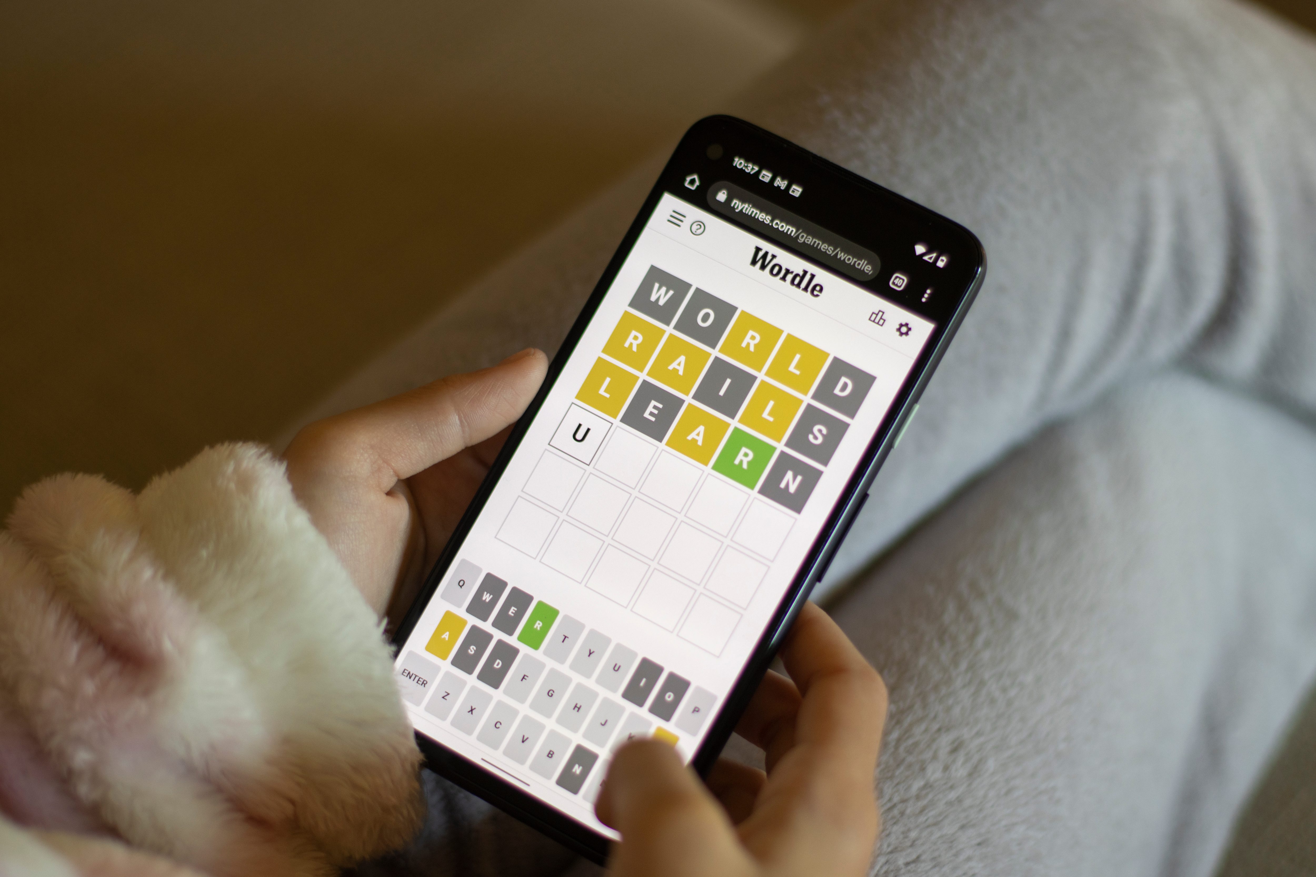 Woman playing Wordle on her smartphone.