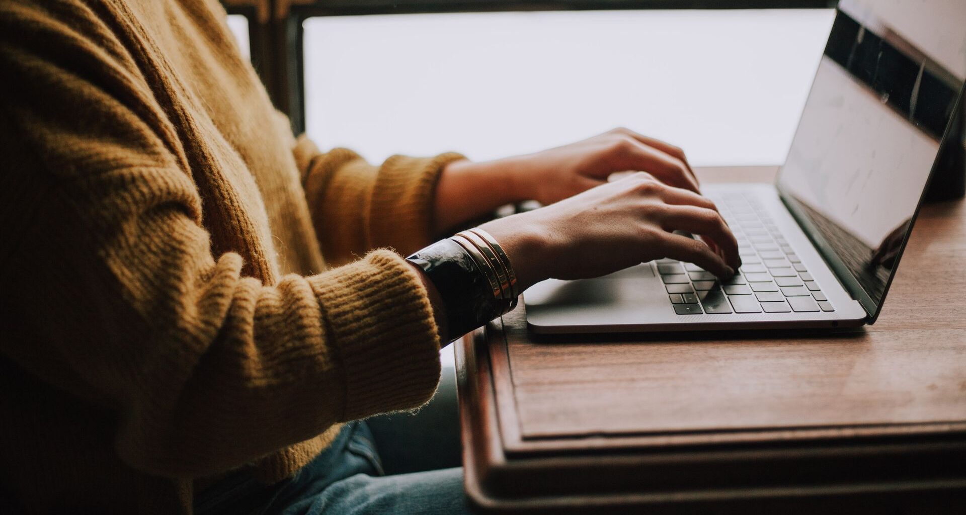 Person typing on laptop keyboard