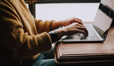 Person typing on laptop keyboard