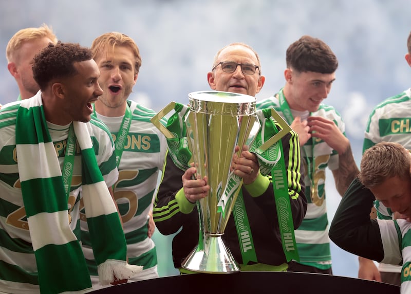 Martin O'Neill, manager of Celtic, lifts the Scottish Premiership trophy. Photograph: Ian MacNicol/Getty