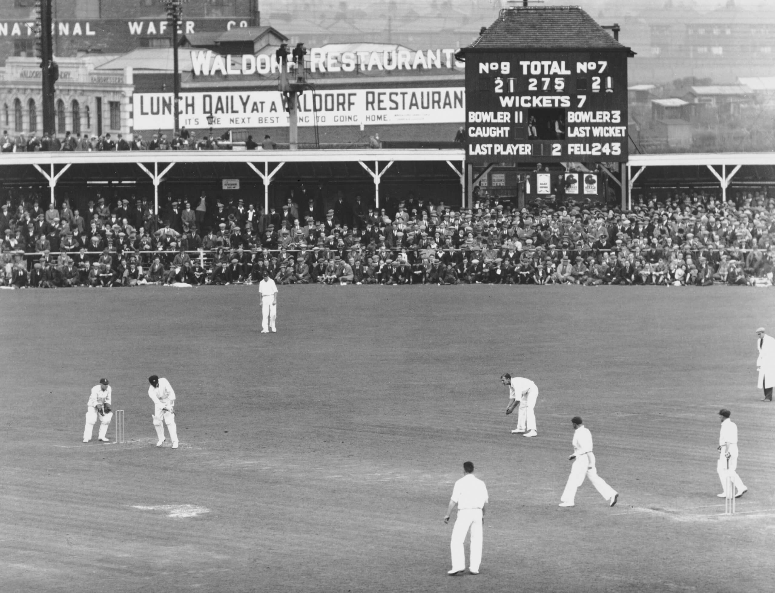 Crowds watch Australia's Clarrie Grimmett bat against England at the Old Trafford Test match of 1930