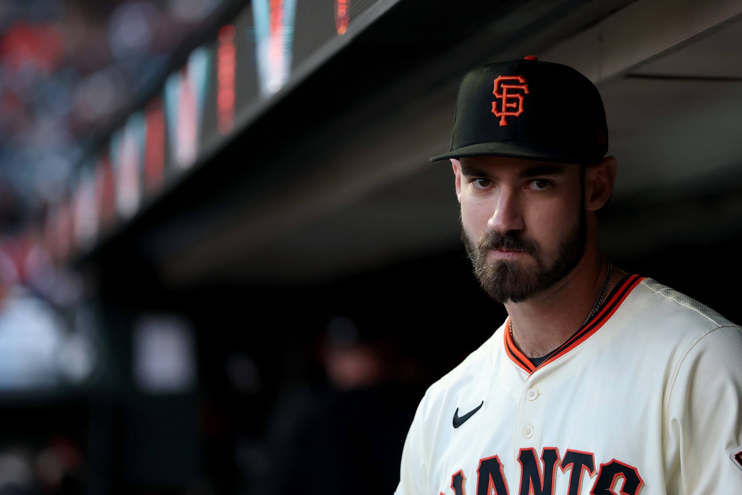 Close-up view of Bryce Eldridge in his jersey and ball cap with the blurred dugout in the background.