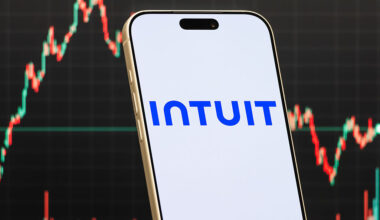 a smartphone displays the logo of Intuit Inc