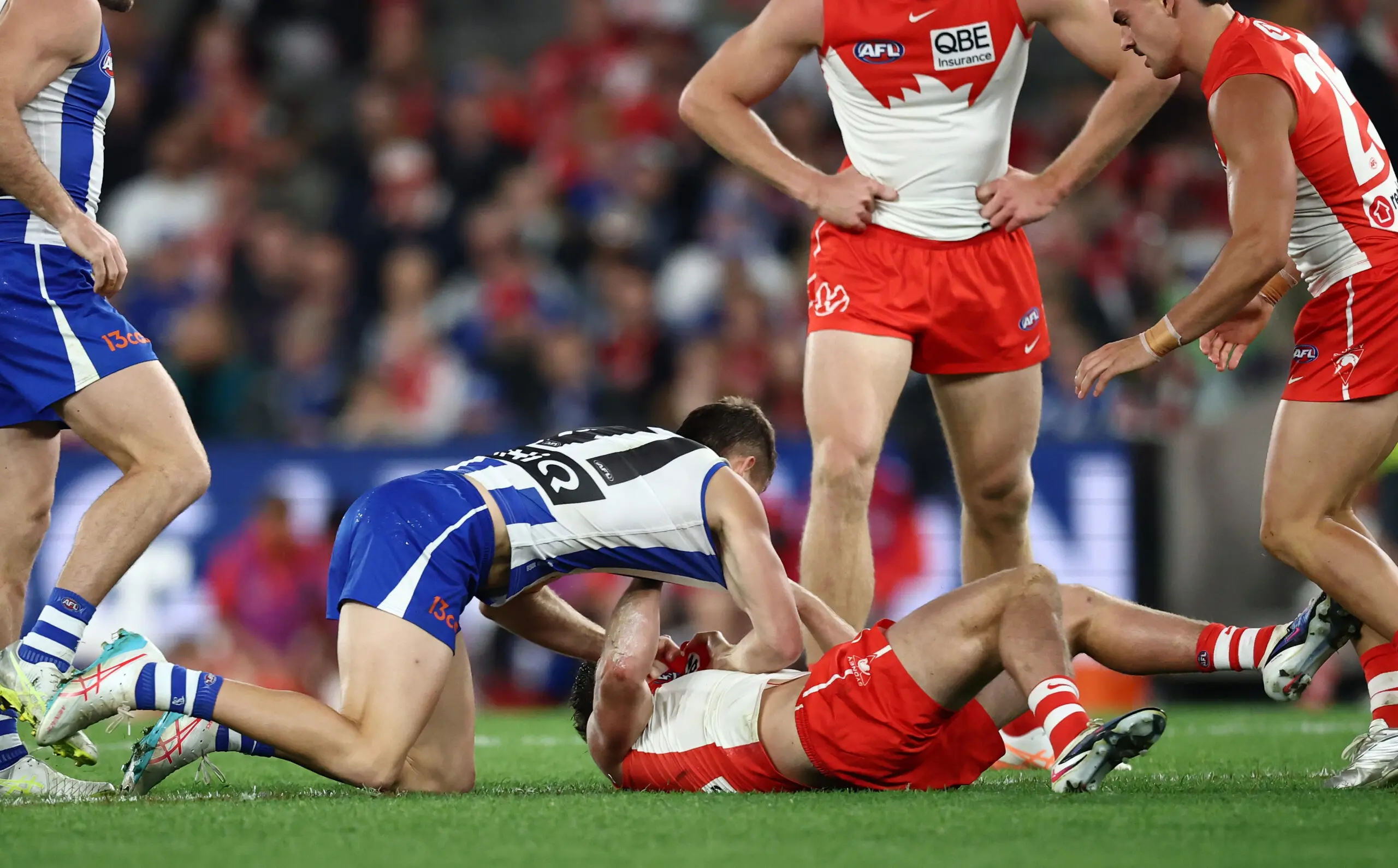 MELBOURNE, AUSTRALIA - MAY 09: Jacob Konstanty of the Kangaroos and Tom Papley of the Swans wrestle during the 2026 AFL Round 09 match between the North Melbourne Kangaroos and the Sydney Swans at Marvel Stadium on May 9, 2026 in Melbourne, Australia. (Photo by James Wiltshire/AFL Photos via Getty Images)