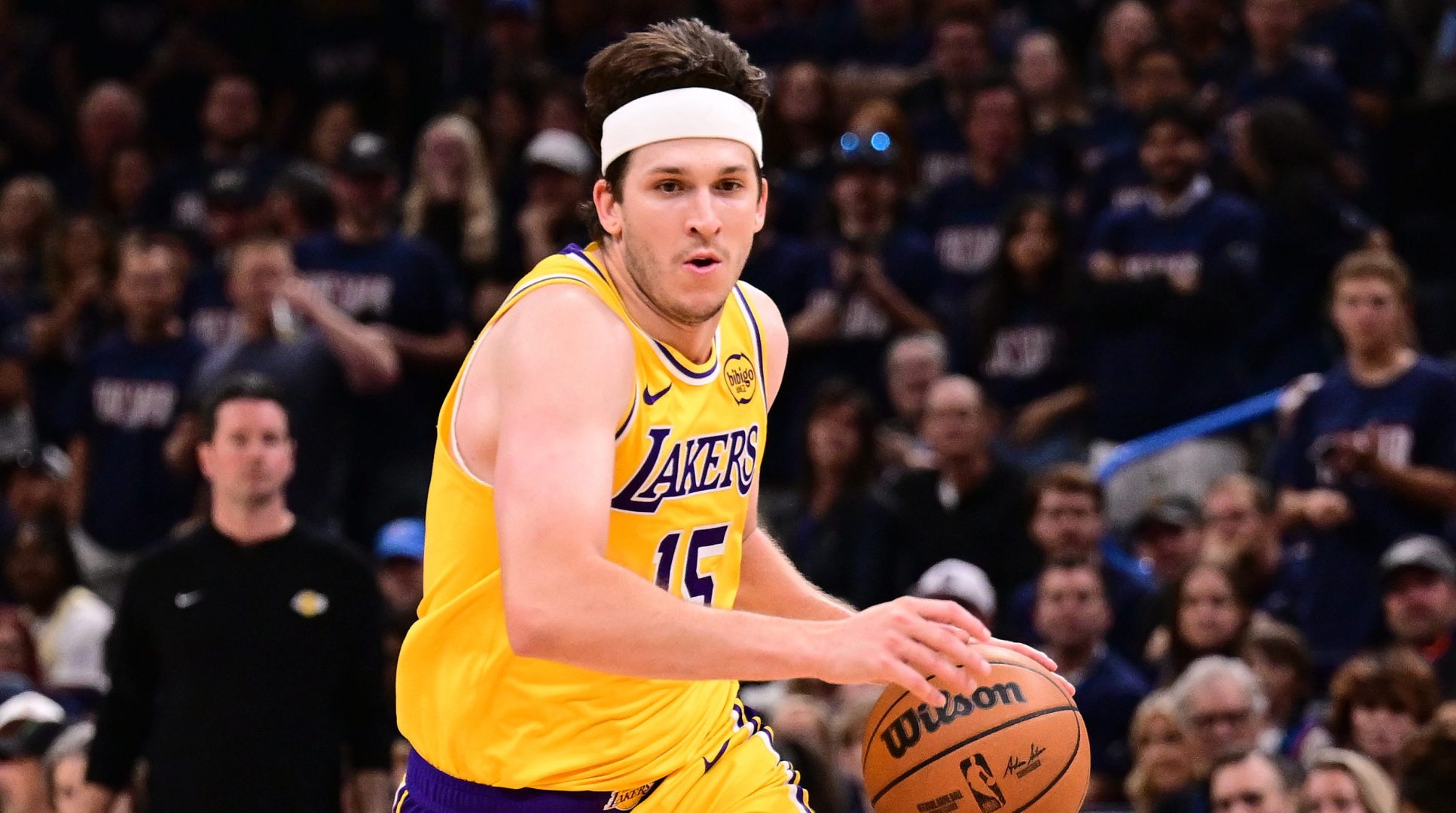 Austin Reaves driving with the ball in Lakers playoff game against defender