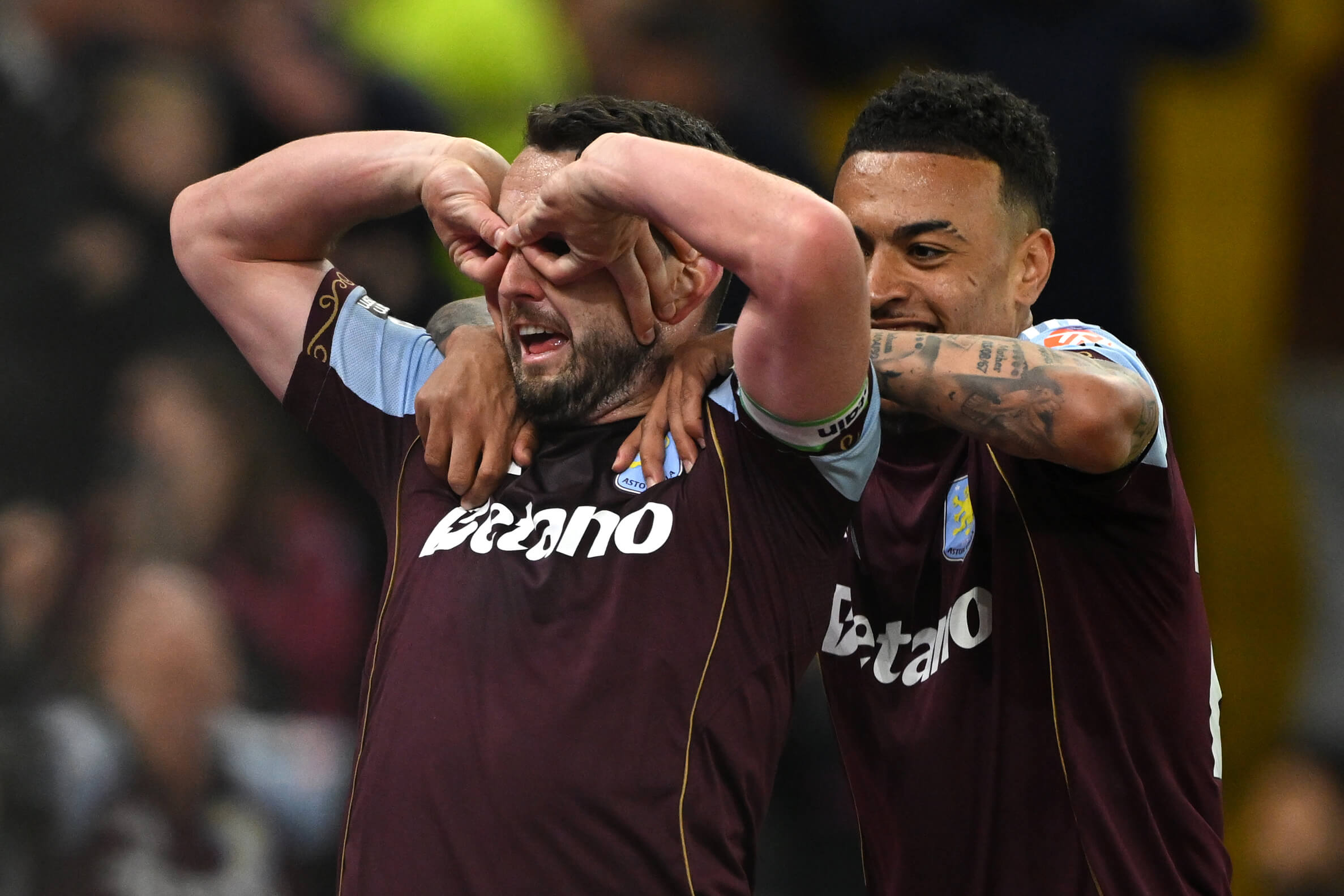 John McGinn celebrates scoring Aston Villa's fourth goal against Liverpool by mimicking glasses with his hands