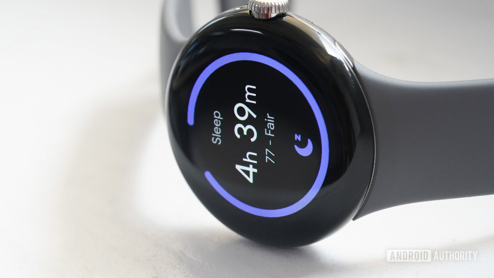 A Google Pixel Watch rests on its side displaying a user's sleep score.