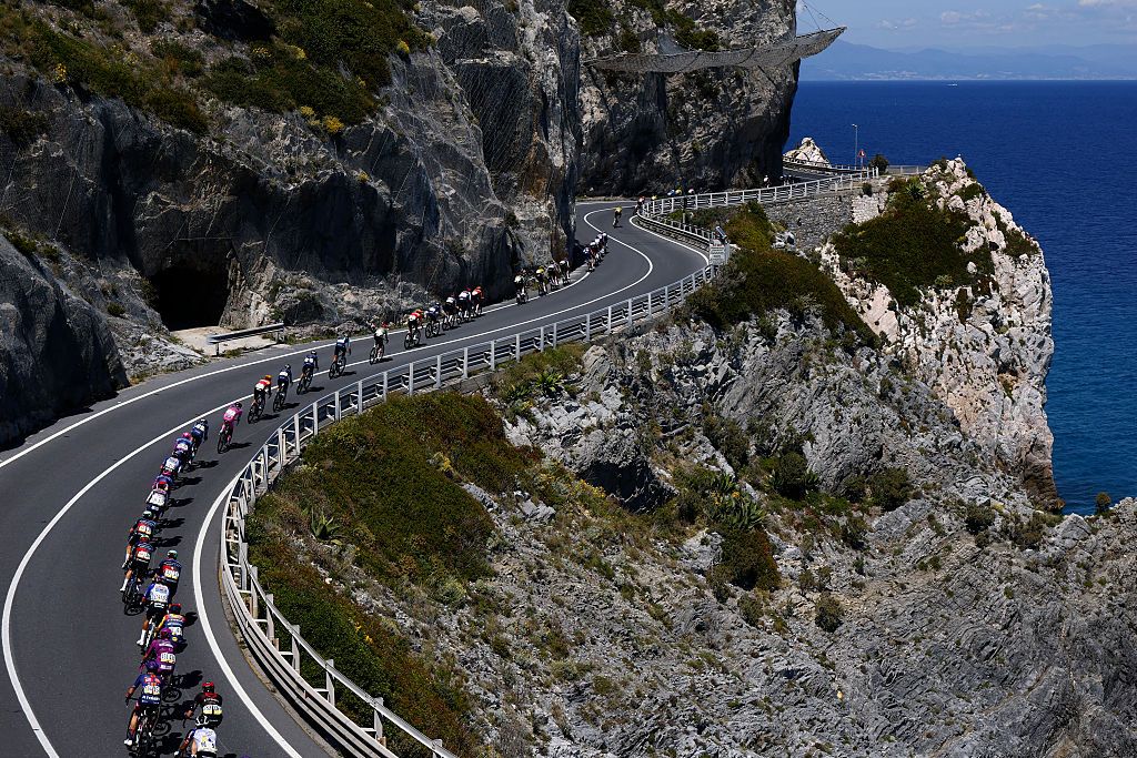 The pack rides at Noli Cape during the 12th stage of the Giro d'Italia 2026 - Tour of Italy cycling race between Imperia and Novi Ligure, Italy, on May 21, 2026. (Photo by Luca Bettini / AFP)