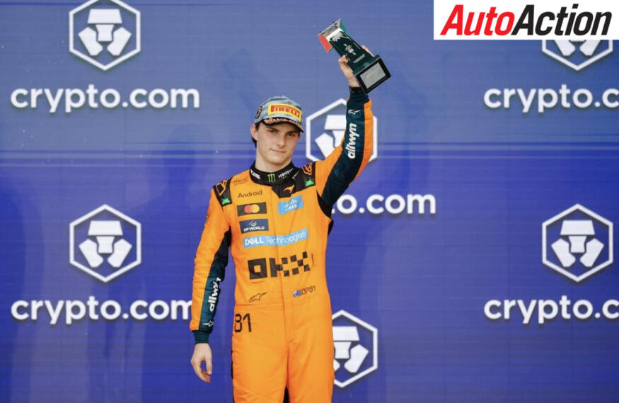 Oscar Piastri, McLaren, raises the third place trophy on the podium after the 2026 F1 Miami Grand Prix.