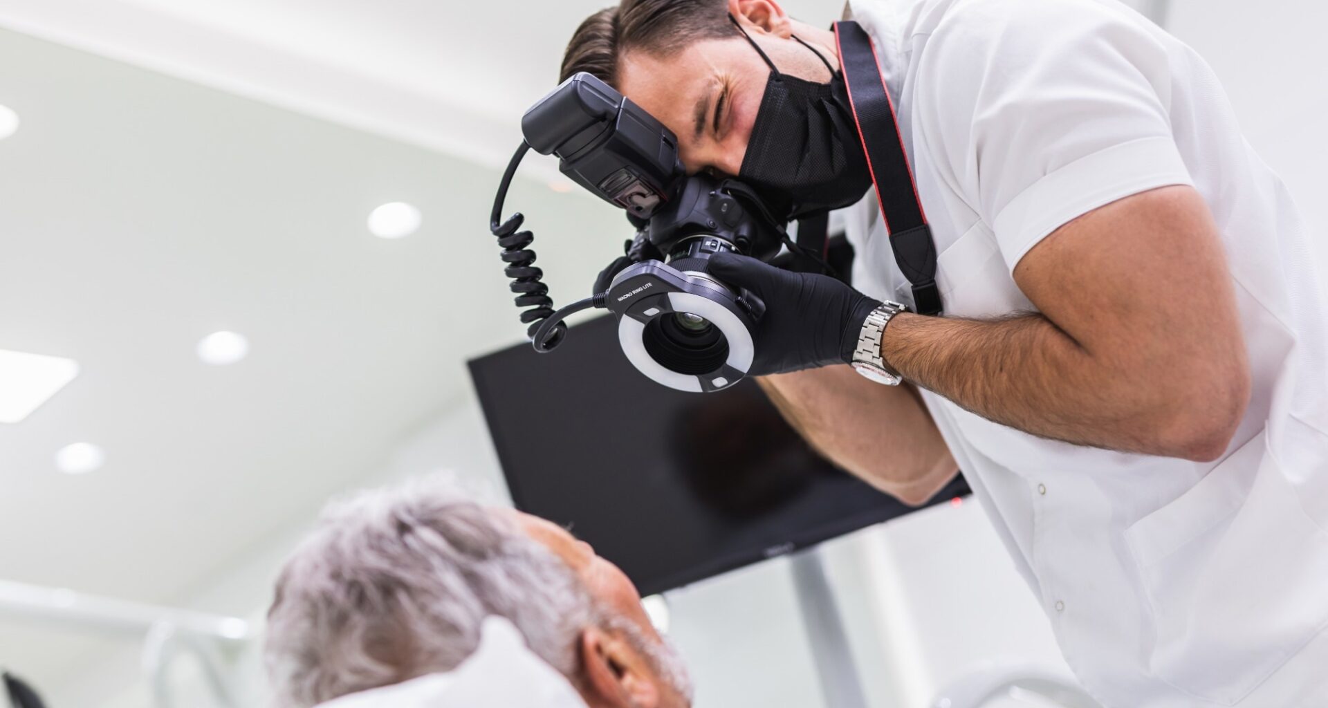healthcare worker taking photographs of mature patient