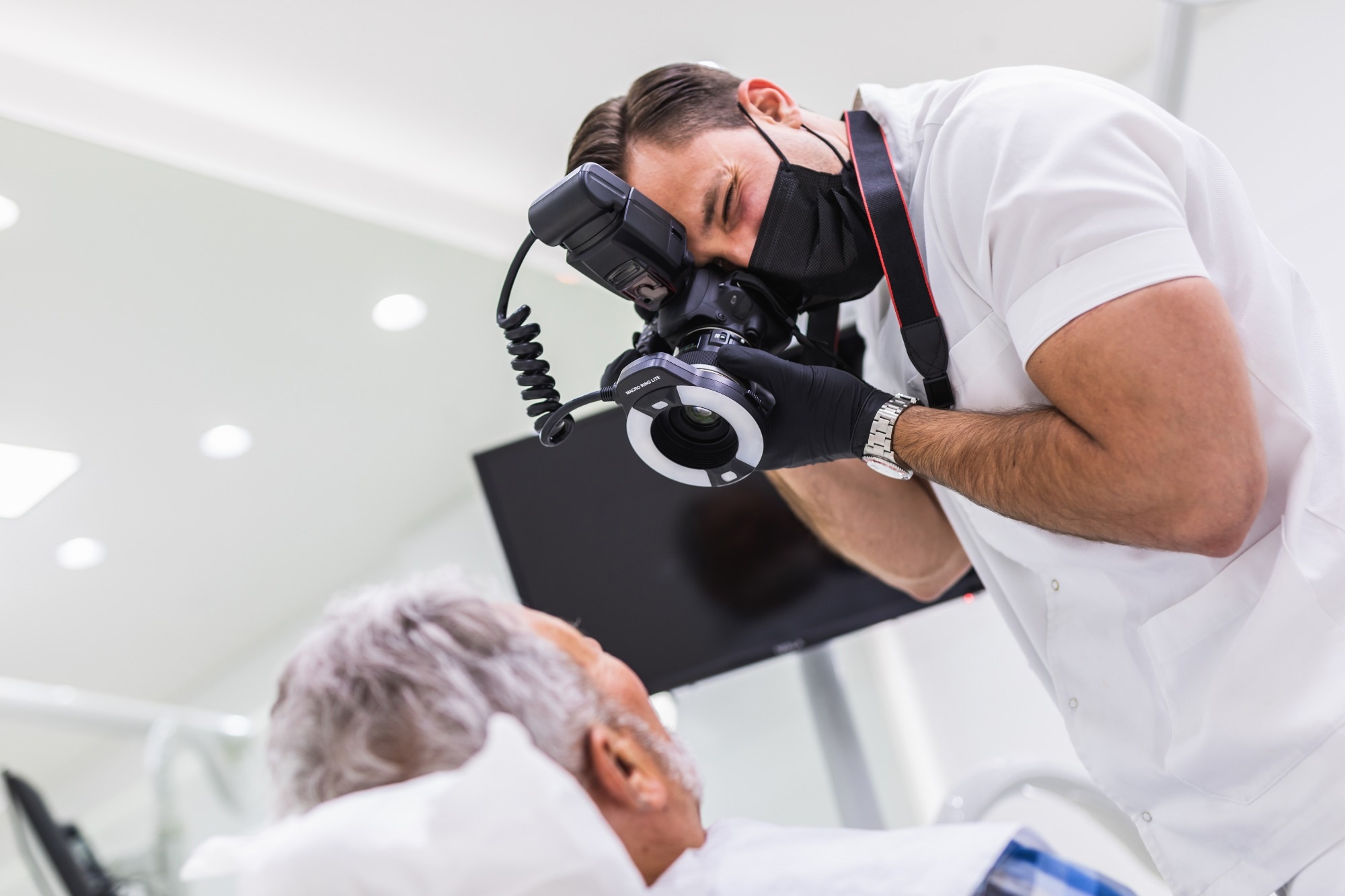 healthcare worker taking photographs of mature patient
