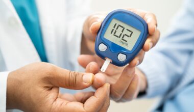 Doctor check diabetes from finger blood sugar level with finger lancet.