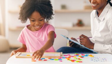 Child Plays With Colorful Shapes While Adult Observes in Bright Indoor Setting