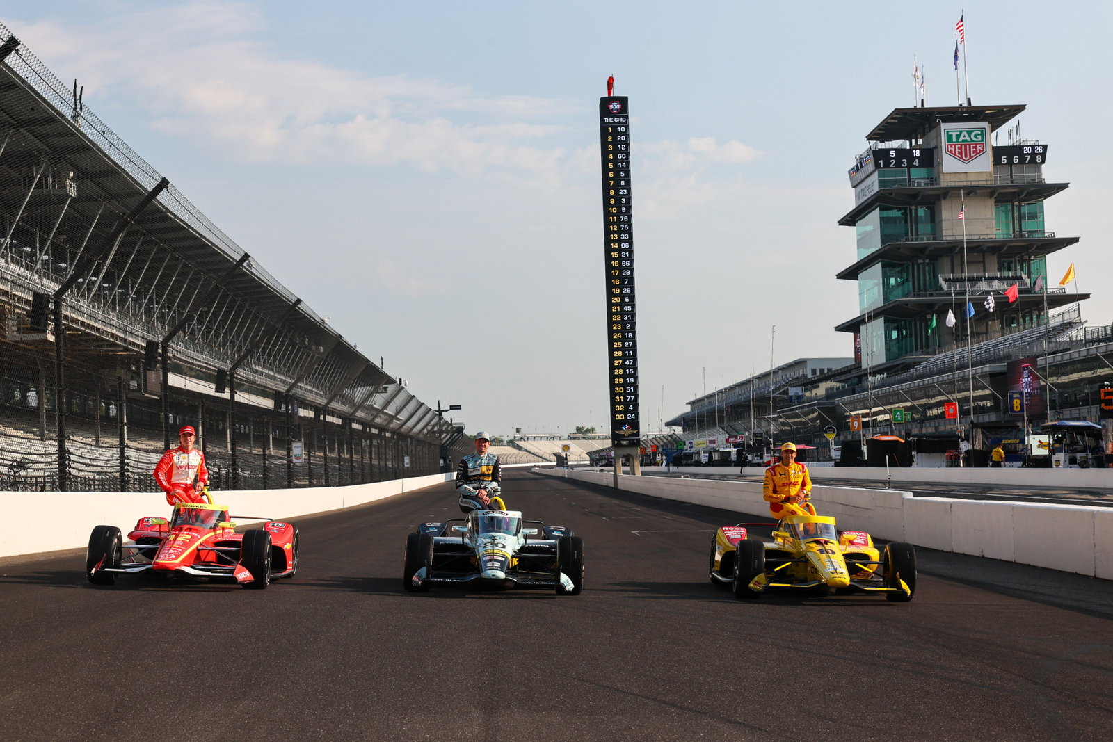 David Malukas (left), Alexander Rossi (middle), and pole position winner Alex Palou pose for the front row photoshoot at Indianapolis Motor Speedway.