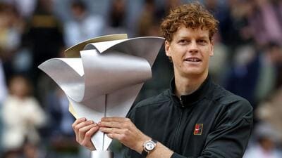 Italy's Jannik Sinner celebrates with the trophy after winning the 2026 ATP Tour Madrid Open. (AFP)