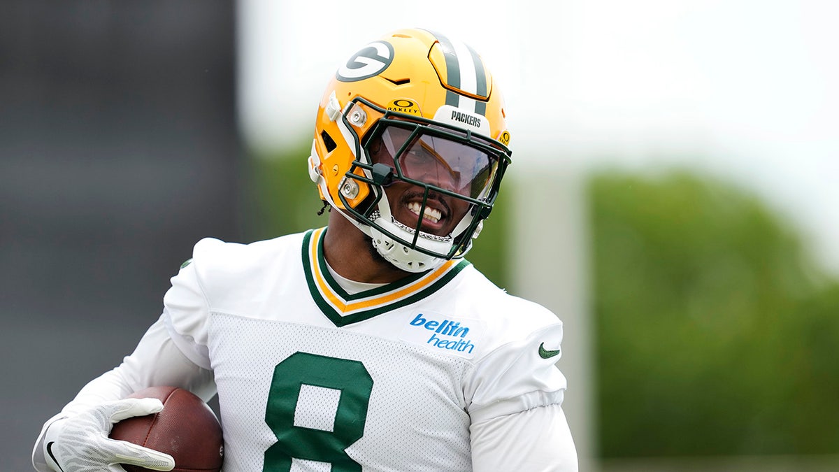 Josh Jacobs wearing number 8 participates in drills on a football field.