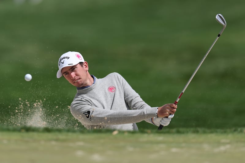 Tom McKibbin chips from the rough at Aronimink Golf Club. Photograph: Andrew Redington/Getty Images