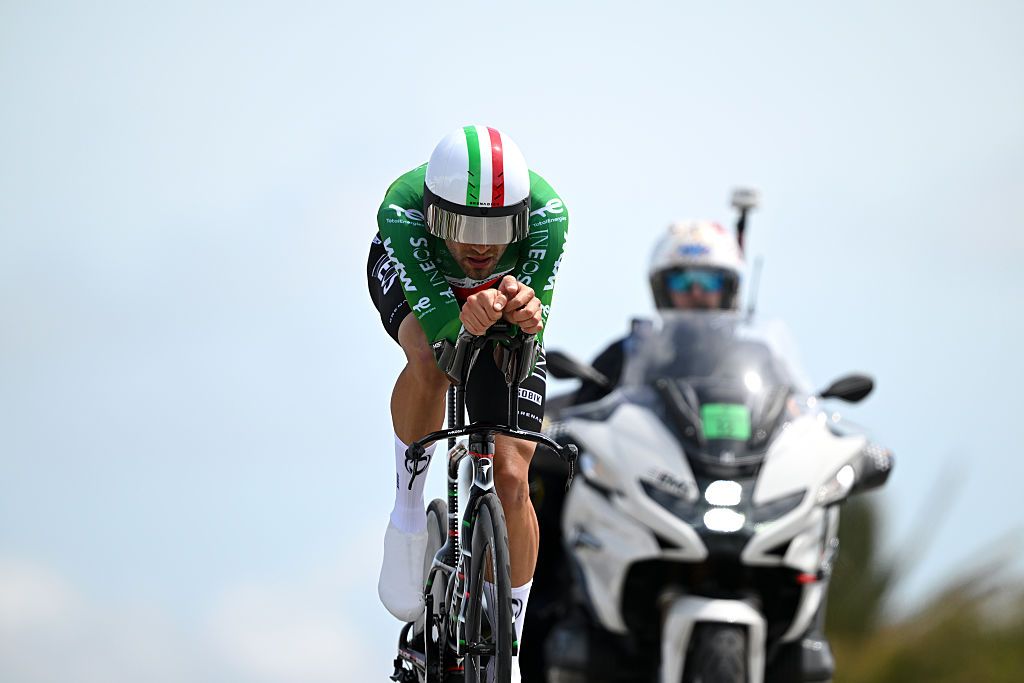 Filippo Ganna rides ahead of a motorbike during the time trial