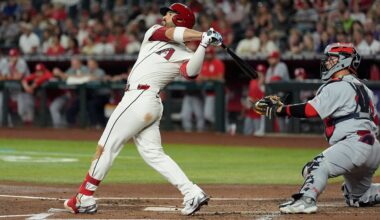 Arizona Diamondbacks' Eugenio Suárez, left, watches the flight of his three-run home run as St. Louis Cardinals catcher Yohel Pozo, right, looks on during the first inning of a baseball game Sunday, July 20, 2025, in Phoenix.