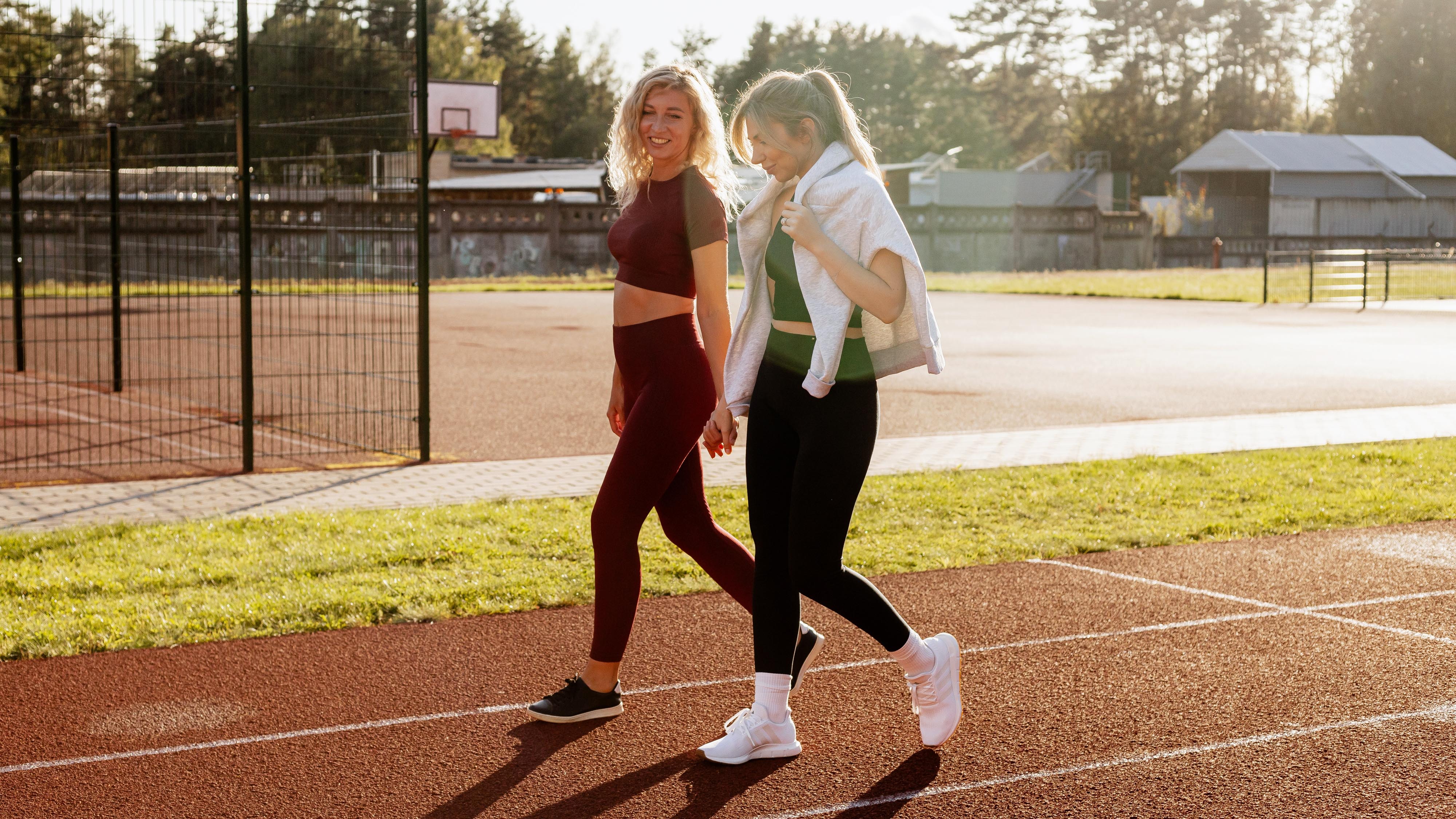 two women walking on a track