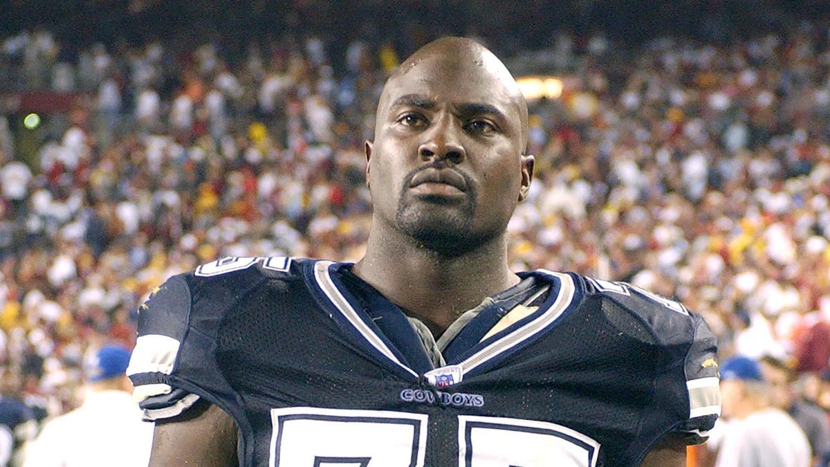 Marcellus Wiley of the Dallas Cowboys looking on the field during a football game.
