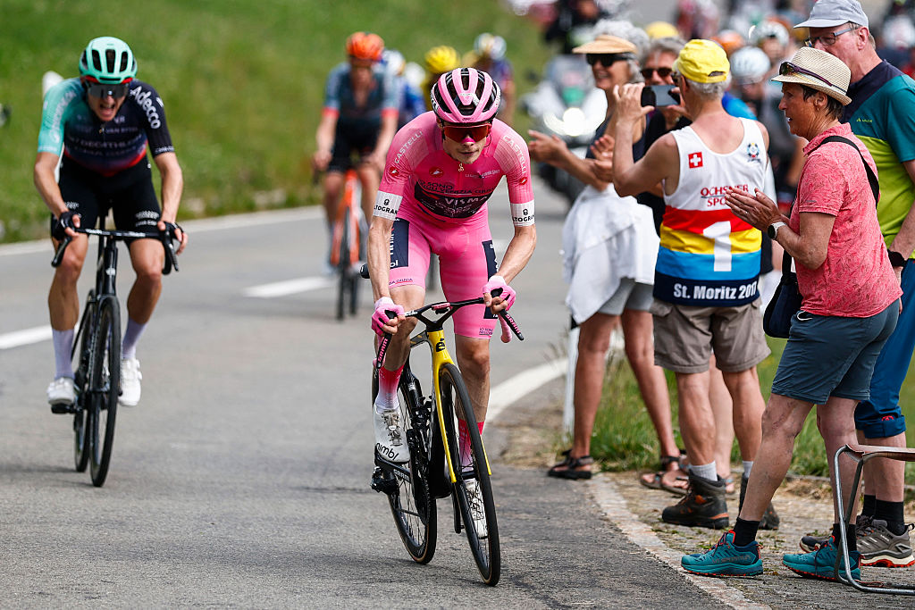 Team Visma Lease a Bike Danish rider Jonas Vingegaard wearing the overall leader's pink jersey (Maglia Rosa) attacks in the final climb during the 16th stage of the Giro d'Italia 2026 - Tour of Italy cycling race between Bellinzona and Cari, Switzerland, on May 26, 2026. (Photo by Luca Bettini / AFP)
