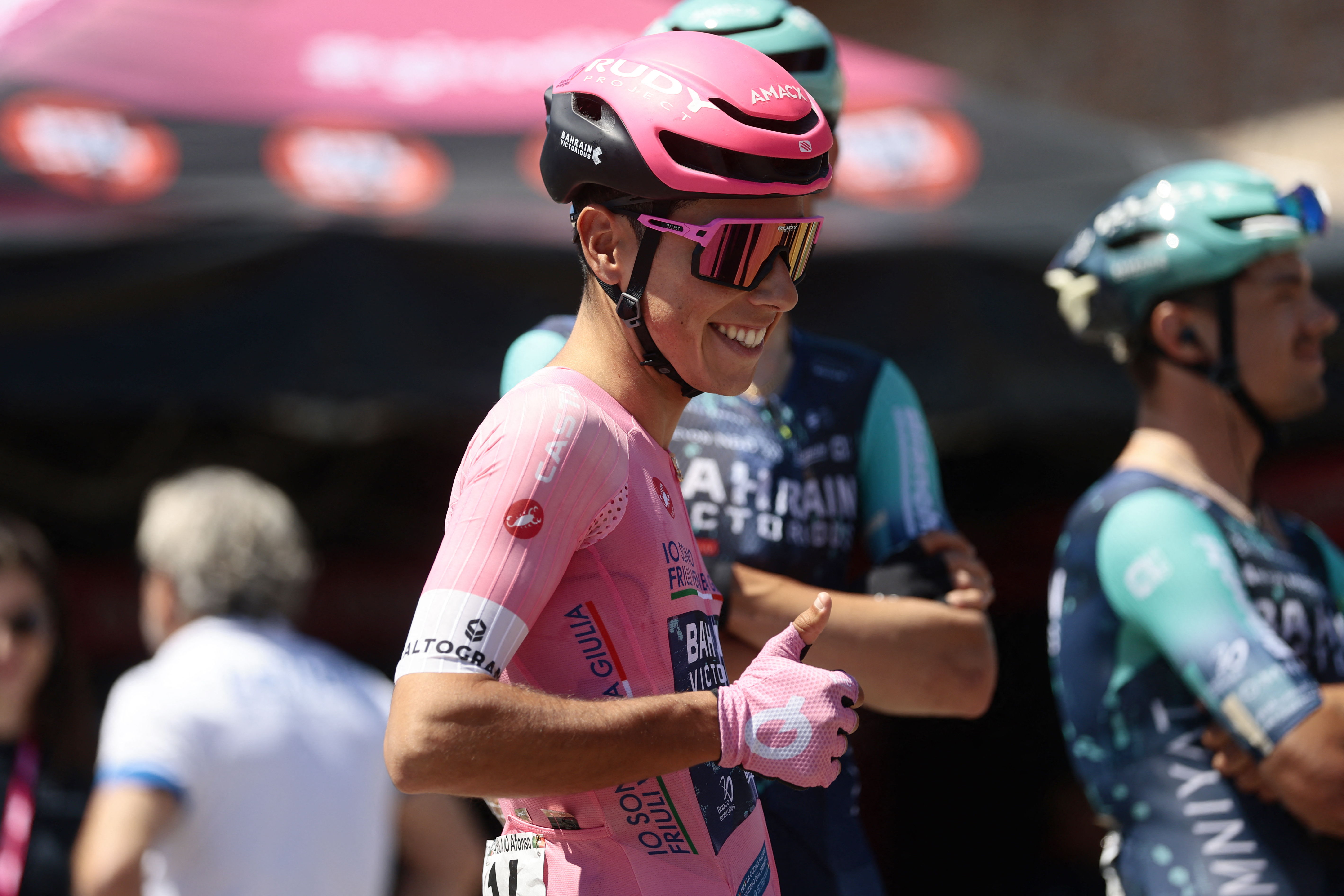 Bahrain - Victorious Portuguese rider Afonso Eulalio, wearing the overall leader's pink jersey (Maglia Rosa), gestures before the 9th stage of the Giro d'Italia 2026 - Tour of Italy cycling race between Cervia and Corno alle Scale, central Italy on May 17, 2026. (Photo by Luca Bettini / AFP)