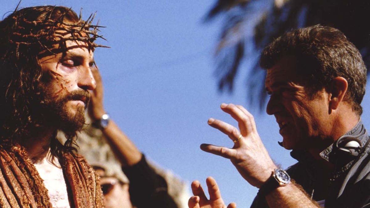 Jim Caviezel and Mel Gibson posing for a photo