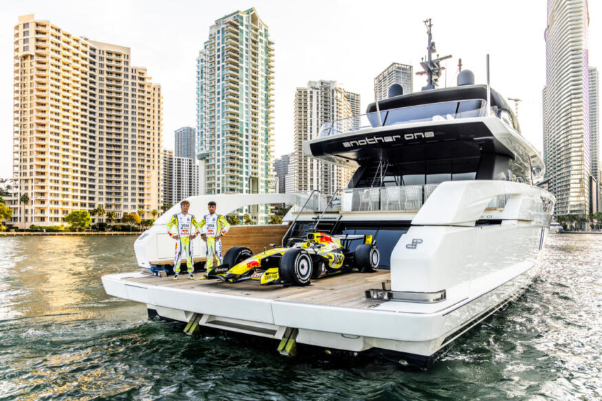 Liam Lawson and Arvid Lindblad pose for a portrait with VCARB 03 during the Miami Special livery reveal for 2026, in Miami, Florida.