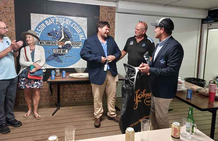 Nelson Bay rugby prop Nathan McLeay receives his 100th senior games jacket from club president Gavin Rocher.