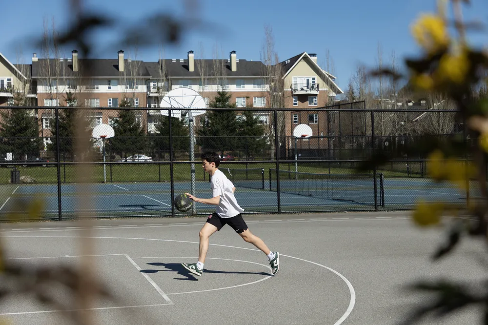 Ian dribbles up the court at Totem Park.