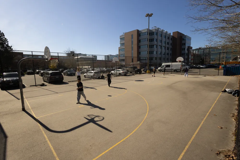 A wide view of the three hoops at the skate park courts.