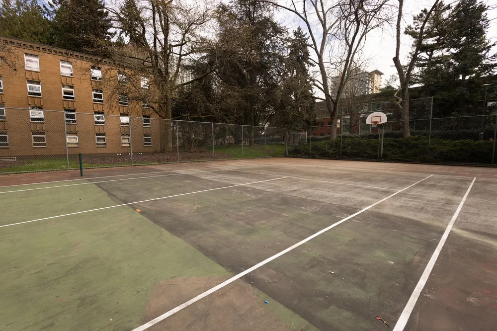 A wide view of the Place Vanier court, showing the former tennis court lines.