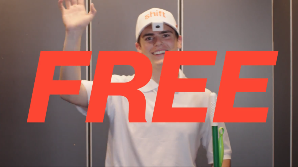 A person wearing a white hat with the word "Shift" and a camera attached to the hat brim is waving and smiling while holding a cleaning mop and Swiffer. The word "Free" in big red letters is in the foreground.
