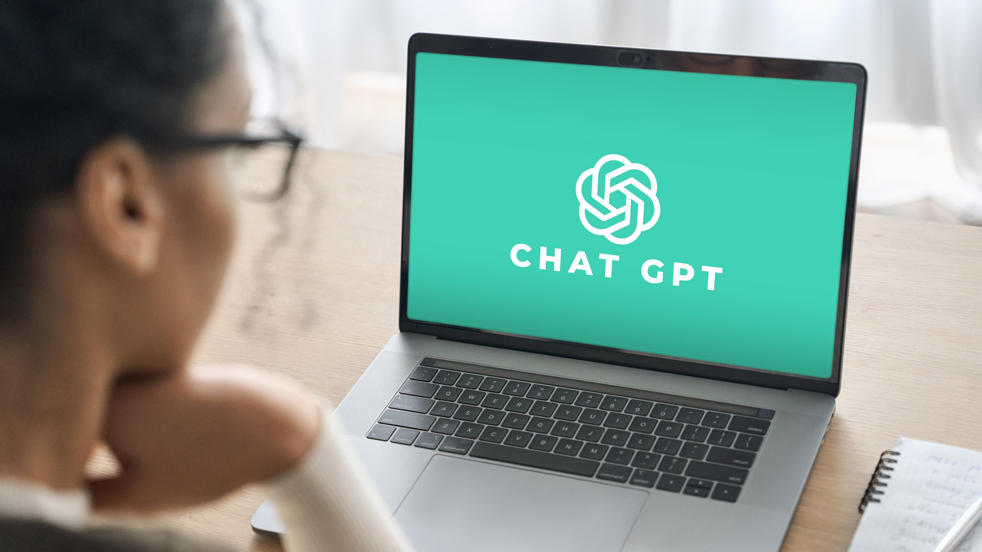 woman using ChatGPT AI on a laptop 