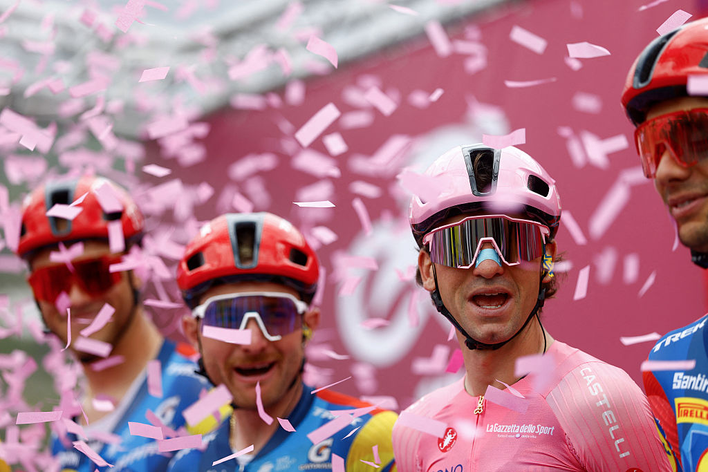Giulio Ciccone wearing the overall leader's pink jersey reacts on the podium as he arrives ahead of the 5th stage of the Giro d'Italia 2026
