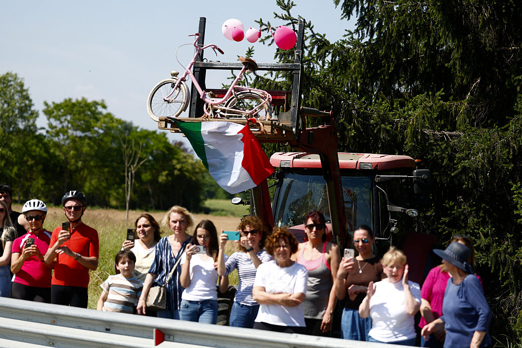 People stand on the side of the road to watch the riders near Novara during the 13th stage of the Giro d'Italia 2026 - Tour of Italy cycling race between Alessandria and Verbania, Italy, on May 22, 2026. (Photo by Luca Bettini / AFP)