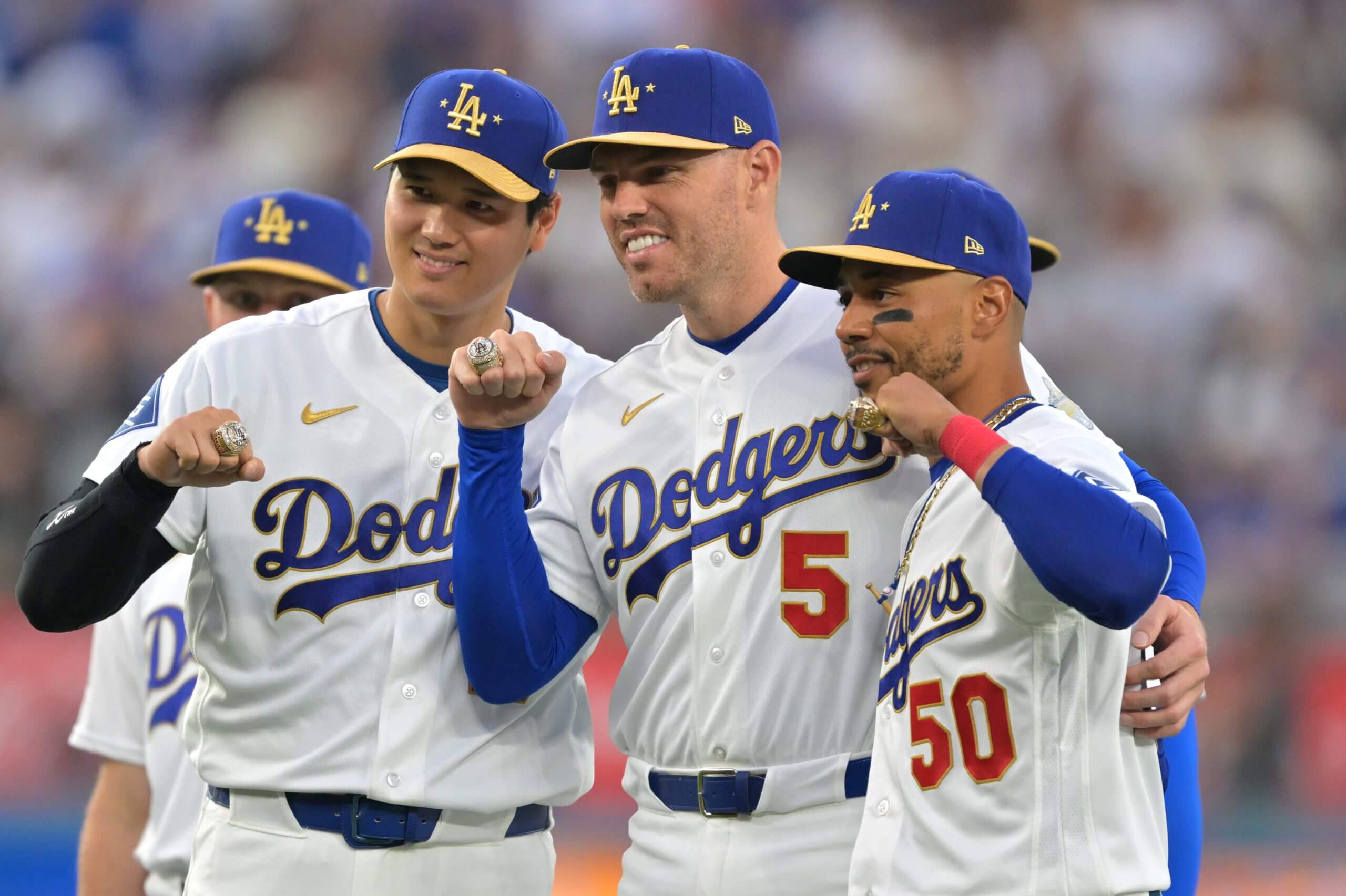 Dodgers two-way player Shohei Ohtani (17) poses with first baseman Freddie Freeman (5) and shortstop Mookie Betts (50) during the World Series ring ceremony before the game against the Arizona Diamondbacks at Dodger Stadium. 