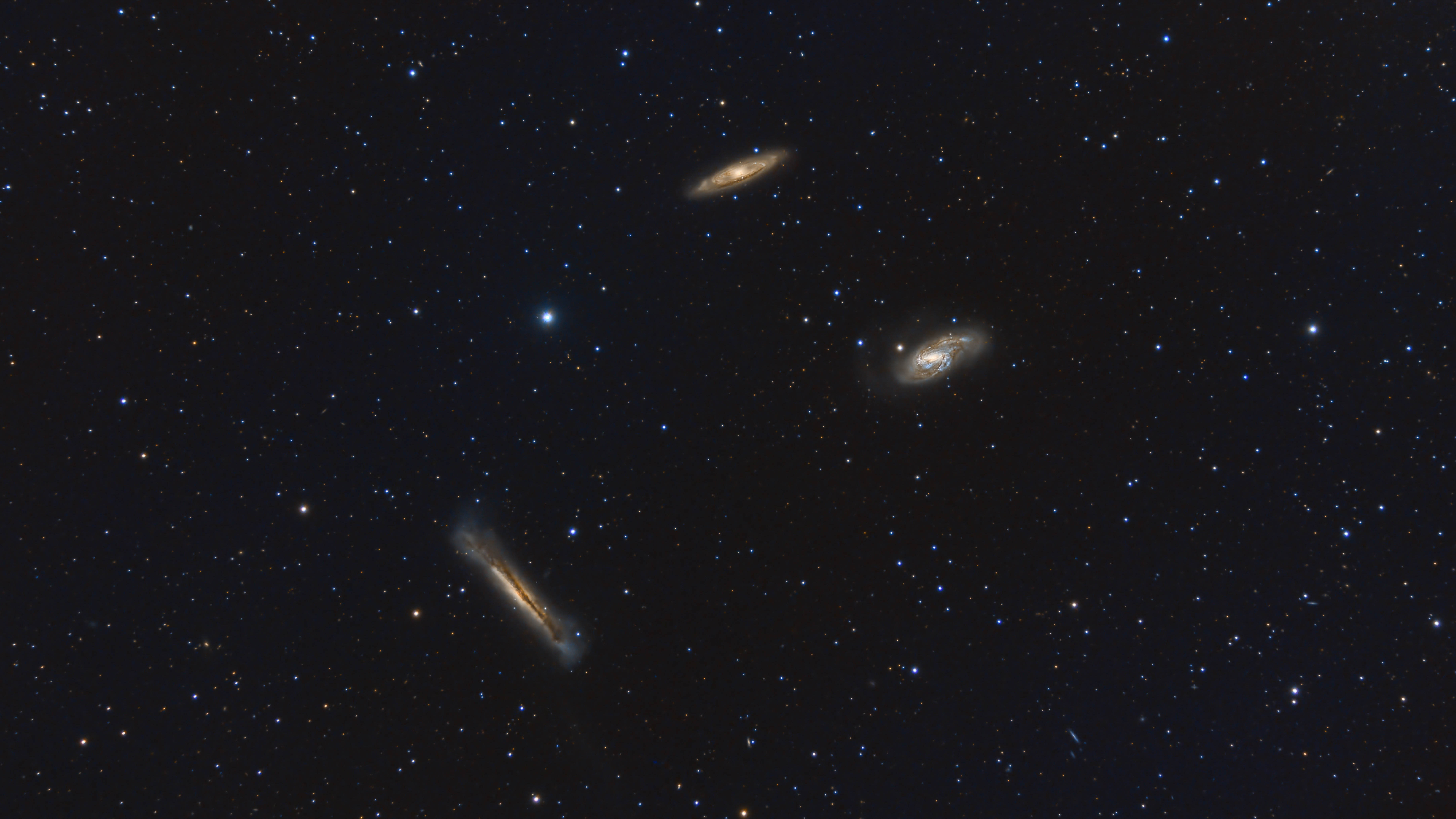 Leo Triplet Surrounded By Stars - stock photo The Leo Triplet is a small group of galaxies about 35 million light-years away in the constellation Leo. This galaxy group consists of the spiral galaxies M65, M66, and NGC 3628.