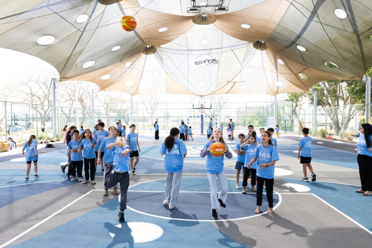 Renovating Israeli basketball courts, ballplayer Jared Armstrong offers respite to war-weary kids