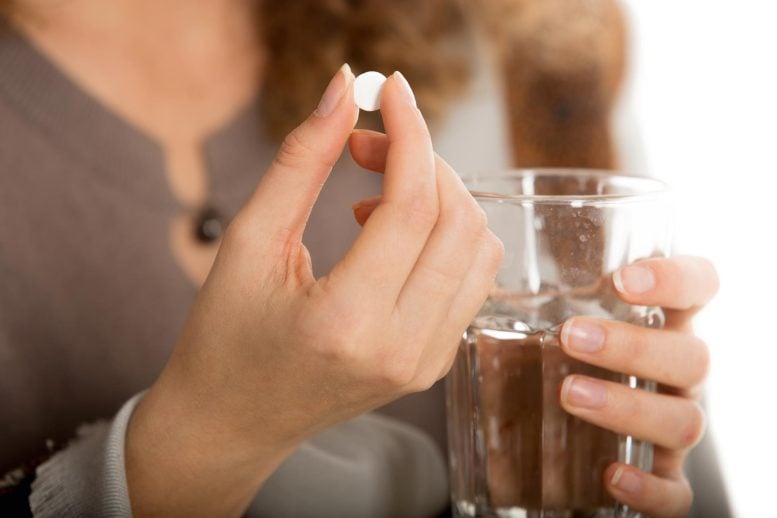 Woman Hand Holding White Pill Water Glass