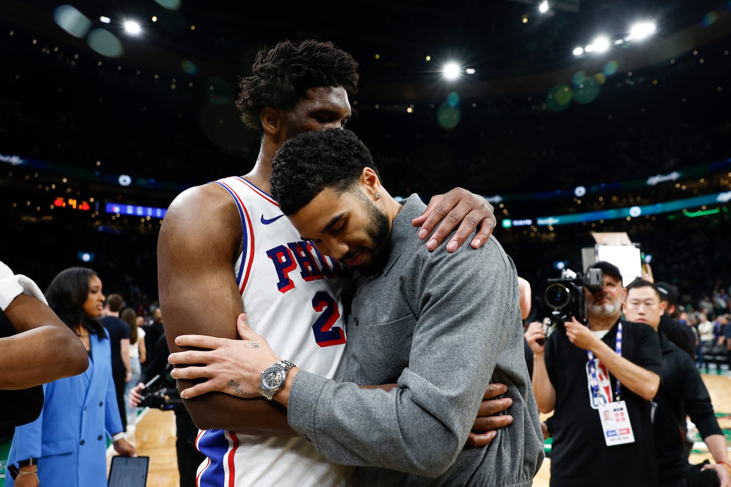 76ers center Joel Embiid (left) and Jayson Tatum embrace after Game 7.