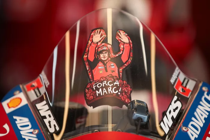 A Forza Marc sticker on the Lenovo Ducati in the garage.